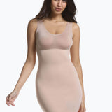 Front view of a model wearing Tone Your Body Dress in cappuccino, body-contouring tank dress. Smooth powerful recycled fabric providing firm shaping for upper body, hips, and legs, with seamless edges, smooth shoulders, and silicone-lined leg openings visible.