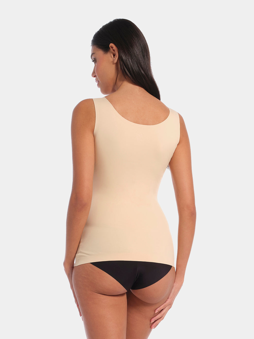 Latte shaping tanktop worn by a model in a back-facing standing position, featuring firm waist and back shaping, seamless invisible finish, smooth flat edges, and strong recycled fabric for a sculpted fit.
