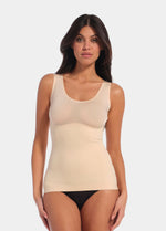 Latte shaping tanktop worn by a model in a front-facing standing position, featuring firm tummy, waist, and back shaping, seamless invisible finish, smooth shoulder straps, and strong recycled fabric with non-compression bust area.