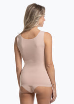 Cappuccino shaping tanktop worn by a model in a back-facing standing position, featuring firm waist and back shaping, seamless invisible finish, smooth flat edges, and strong recycled fabric for a sculpted fit.

