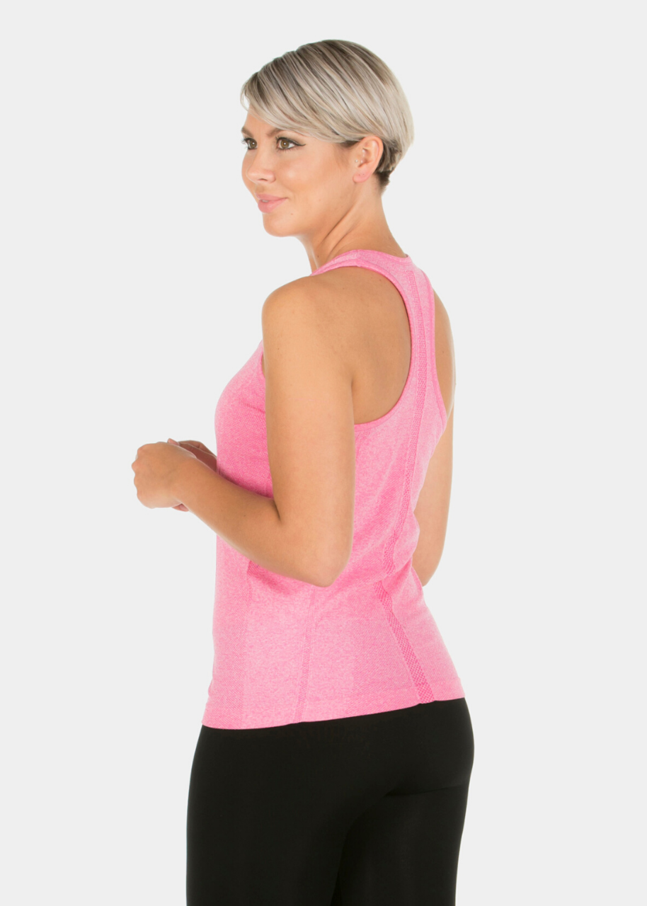 A woman wearing the pink YOGA Top from Magicbodyfashion