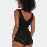 Person wearing a black bodysuit with lace details on a white background
