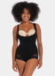 Woman wearing a black bodysuit with a beige bralette on a white background
