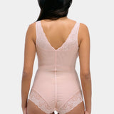 Woman wearing a beige bodysuit with lace details on a white background