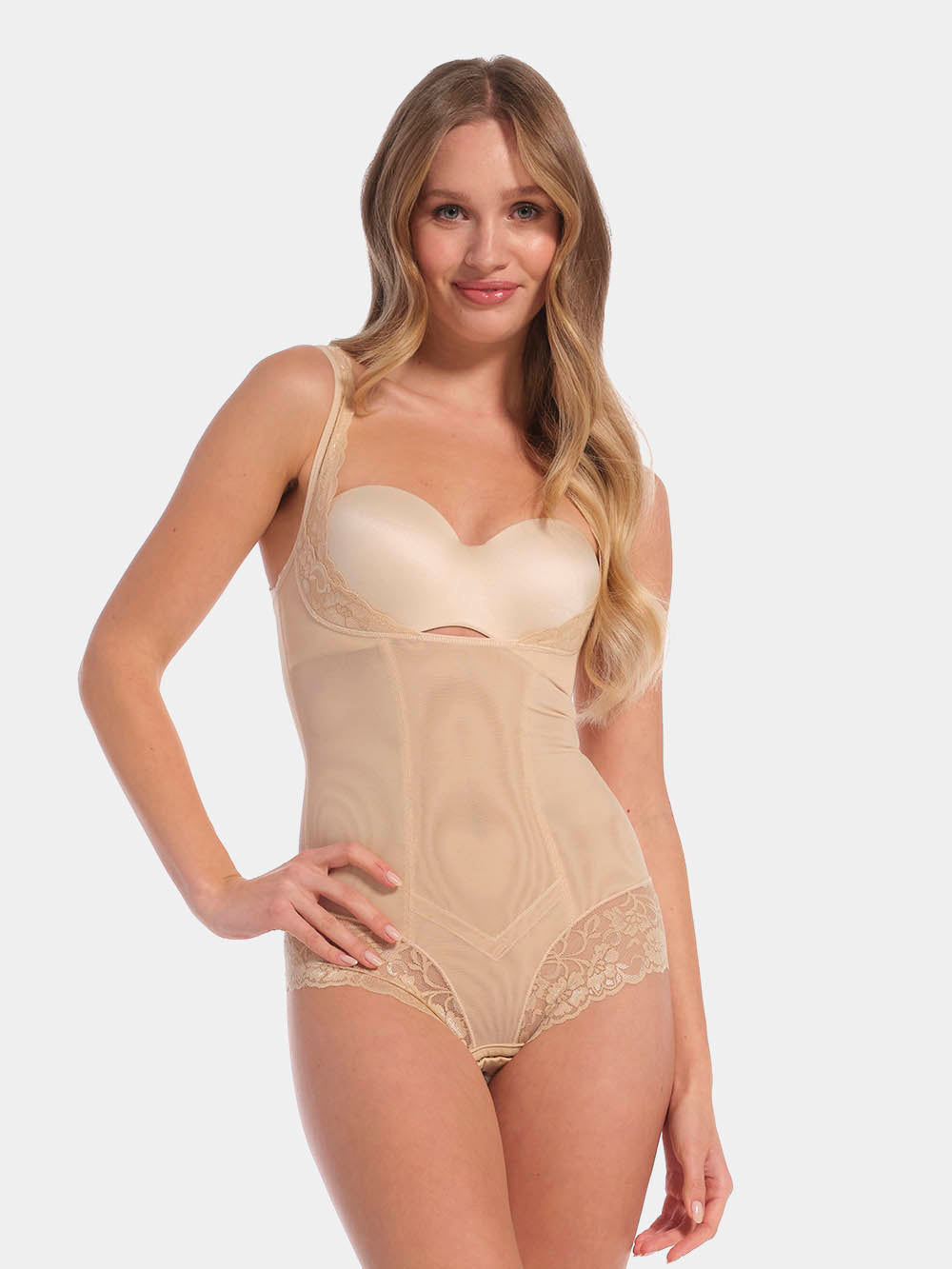 Woman wearing a beige shapewear bodysuit on a white background