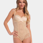 Woman wearing a beige shapewear bodysuit on a white background