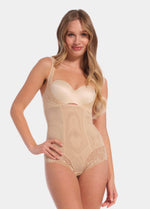 Woman wearing a beige shapewear bodysuit on a white background