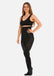 Front view of a model wearing Hi-Waist Slim Tights in black, 140 denier high-waist shaping tights. Smooth opaque fabric providing medium shaping for tummy, hips, and thighs, with silicone-trimmed waistband and reinforced toes visible.