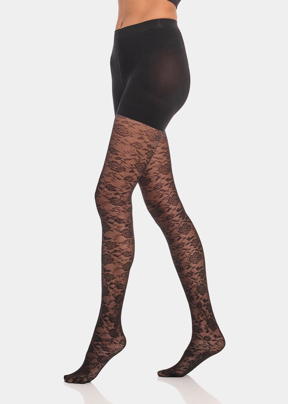 Side view of a model wearing Luxury Legs Lace tights, 20 denier patterned shaping tights. Built-in firm shaping shorts provide control for tummy, hips, and upper legs, with subtle lift at the bottom and reinforced toes visible.