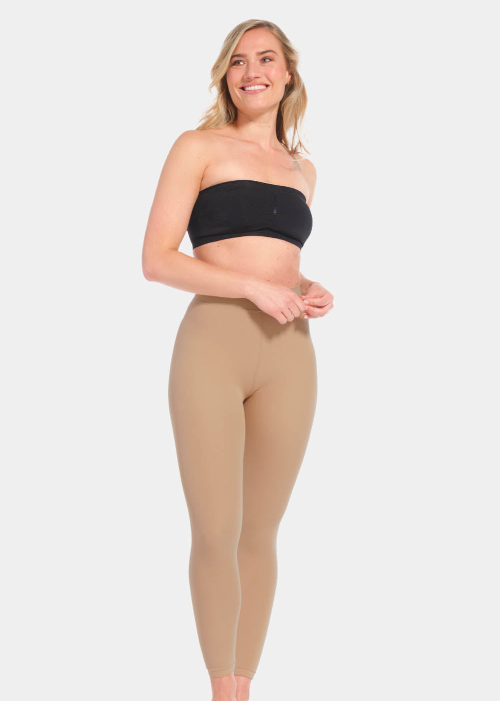 Front view of a model wearing Warm Fleece-Lined MAGIC Leggings in sunshine, high-waist fleece-lined leggings. Smooth fabric providing medium shaping and tummy support, ladder-resistant finish, and translucent-look legs visible.