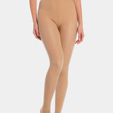 Front view cropped image of a model wearing MAGIC Tights in latte, high-waist warm fleece-lined tights. Smooth fabric providing medium shaping for tummy and waist, ladder-resistant finish, and sheer-look legs with unfleece foot section visible.