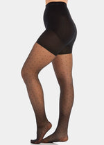 Front view close-up of a model wearing Sexy Dots shaping tights in black, 20 denier sheer tights with dot pattern. Built-in firm shaping shorts providing control for tummy, hips, and upper legs, with subtle lift at the bottom and reinforced toes visible.