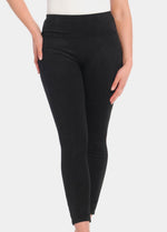 Front view cropped image of a model wearing Suedine Look Legging in black, high-rise leggings with built-in shaping briefs. Soft luxurious faux suede stretch fabric providing medium shaping for tummy, hips, and back, with cotton gusset visible.