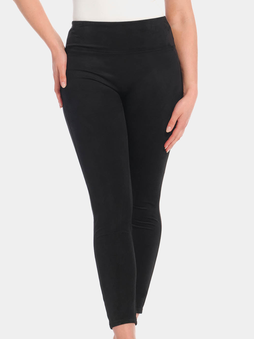 Front view cropped image of a model wearing Suedine Look Legging in black, high-rise leggings with built-in shaping briefs. Soft luxurious faux suede stretch fabric providing medium shaping for tummy, hips, and back, with cotton gusset visible.