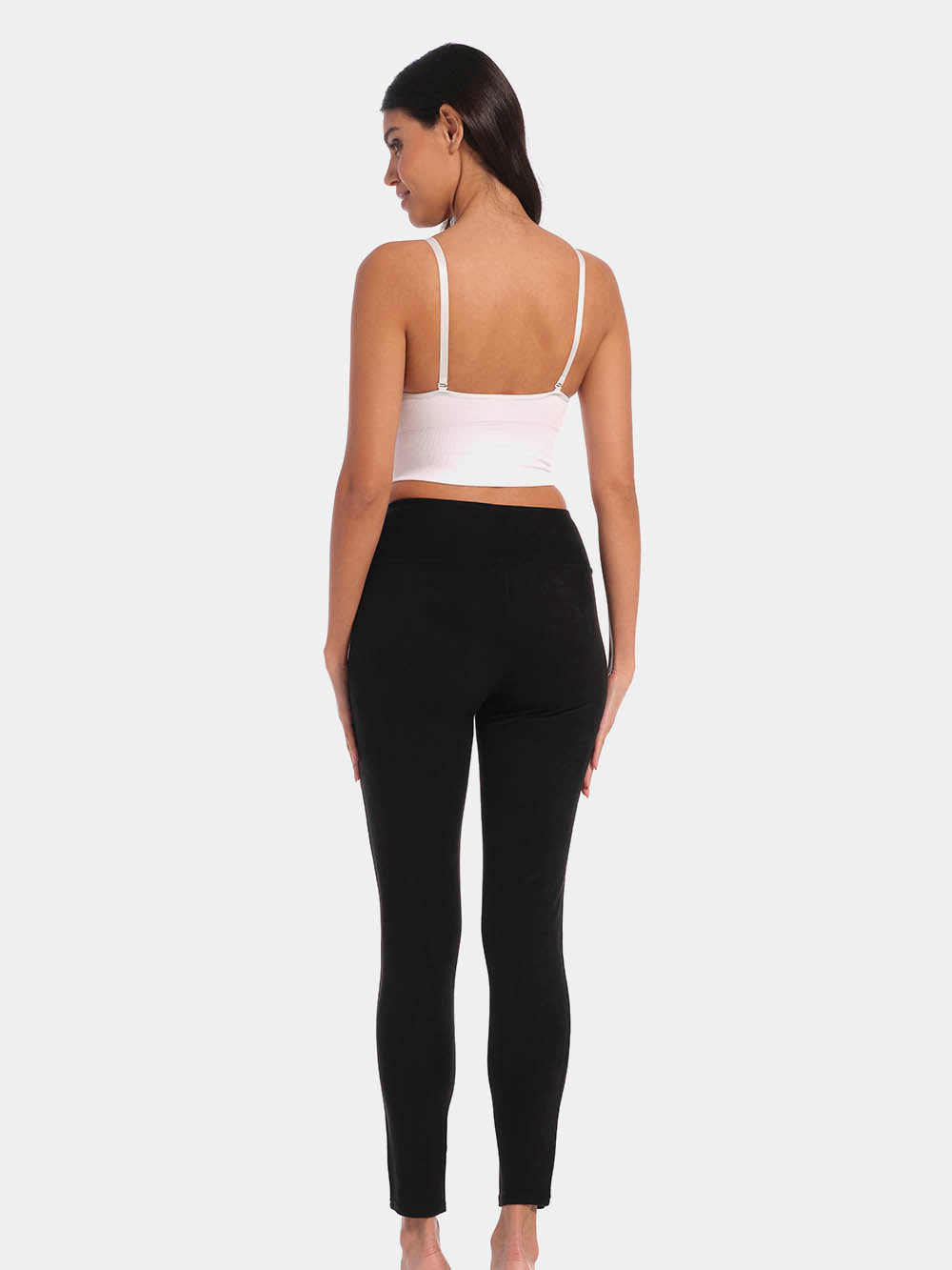 Back view of a model wearing Suedine Look Legging in black, high-rise leggings with built-in shaping briefs. Soft luxurious faux suede stretch fabric providing medium control for lower back and hips, with cotton gusset and smooth finish visible.