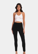 Front view of a model wearing Suedine Look Legging in black, high-rise leggings with built-in shaping briefs. Soft luxurious faux suede stretch fabric providing medium shaping for tummy, hips, and back, with cotton gusset visible.
