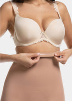 Front view cropped close-up of a model wearing Maxi Sexy Hi-Bermuda in mocha, high-waist mid-thigh shaping shorts. Smooth powerful fabric with silicone-trimmed waistband and seamless edges, showing firm control over tummy, waist, and thighs.