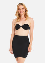Front view of a model wearing Maxi Sexy Control Skirt in black, high-waist shaping skirt. Smooth powerful fabric providing firm control for tummy, hips, and thighs, with built-in tummy shaping zone, silicone-trimmed hem, and seamless edges visible.