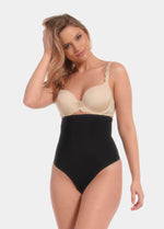 Front view of a model wearing Maxi Sexy Hi-Thong in black, high-waist shaping thong. Smooth powerful fabric providing firm control for tummy, waist, and back, with seamless edges and silicone-trimmed waistband visible.