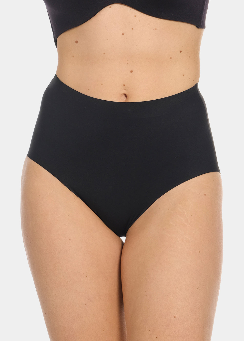 Front view cropped image of a model wearing Maxi Sexy Shaping Brief in black, high-waist shaping brief. Smooth strong recycled fabric providing firm control for tummy, waist, and back, with seamless edges for invisible wear under clothing.