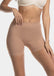 A woman wearing a black maxi sexy short that shapes the lower tummy, hips, and thighs. The short has silicone trim at the leg openings and a seamless edge for an invisible look.