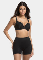 A woman wearing a black maxi sexy short that shapes the lower tummy, hips, and thighs. The short has silicone trim at the leg openings and a seamless edge for an invisible look.