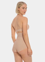 Woman wearing a beige  hi-brief on a white background