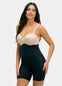 Woman wearing a black shapewear Hi-Bermuda with a beige bra on a white background