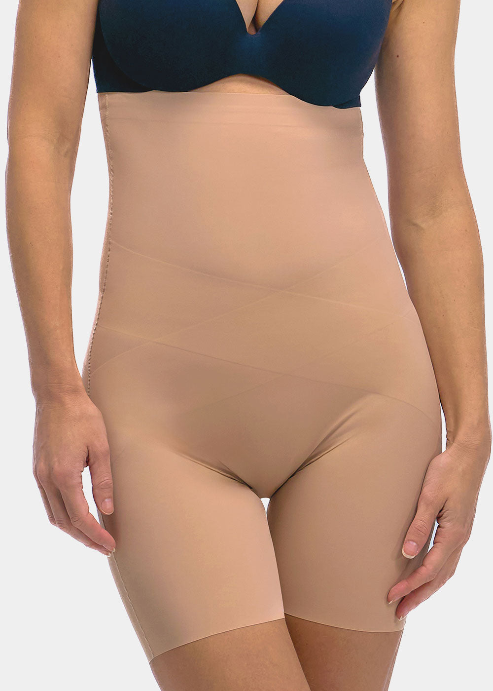 Beige shapewear Hi-Bermuda worn under a blue bra on a white background