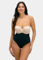Woman wearing a strapless top and high-waisted black  thong on a white background