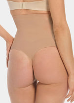 Beige shapewear being worn on a plain background