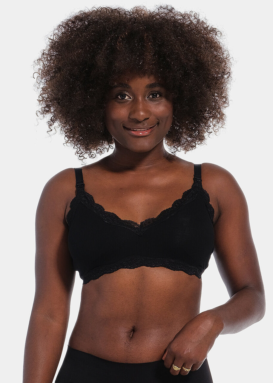 Front view of a model wearing Mama Lace Bralette in black, seamless wire-free nursing bra. Stretch fabric cups with removable pads, clip-down cups for nursing, adjustable straps, and lace trim along the cup edges visible.