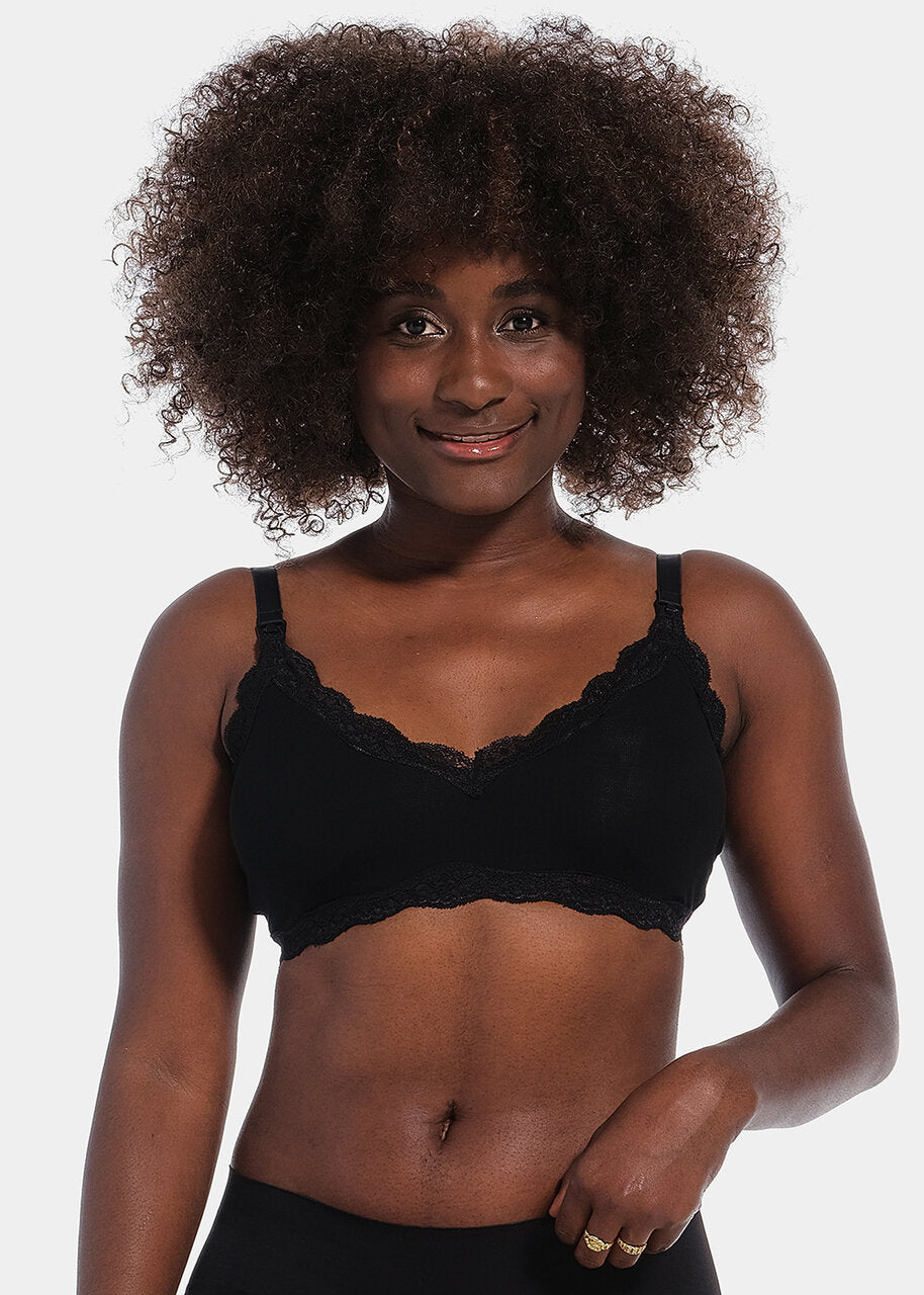 Front view of a model wearing Mama Lace Bralette in black, seamless wire-free nursing bra. Stretch fabric cups with removable pads, clip-down cups for nursing, adjustable straps, and lace trim along the cup edges visible.