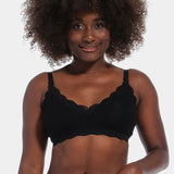Front view of a model wearing Mama Lace Bralette in black, seamless wire-free nursing bra. Stretch fabric cups with removable pads, clip-down cups for nursing, adjustable straps, and lace trim along the cup edges visible.