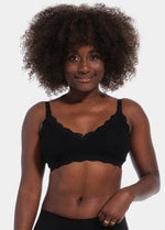 Front view of a model wearing Mama Lace Bralette in black, seamless wire-free nursing bra. Stretch fabric cups with removable pads, clip-down cups for nursing, adjustable straps, and lace trim along the cup edges visible.