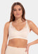 A woman wearing a white Sensual Bra with mesh details at the cups and straps, and a hook-and-eye back closure.