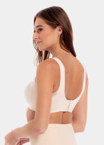A woman wearing a white Sensual Bra with mesh details at the cups and straps, and a hook-and-eye back closure. Showing from an angle