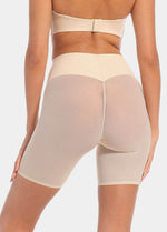 Back view of a model wearing Sheer & Sexy Shaping Short in latte, mid-waist shaping shorts. Smooth fabric with sheer mesh panels and special lift zone at the buttocks, featuring seamless edges for invisible wear.