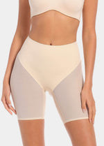 Front view of a model wearing Sheer & Sexy Shaping Short in latte, mid-waist shaping shorts. Smooth fabric with sheer mesh panels, medium shaping for tummy and lower back, and special lift zone at the buttocks visible.