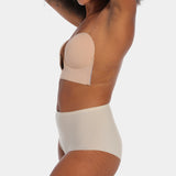 Person wearing a cappuccino strapless LUve Bra with a plain background. 