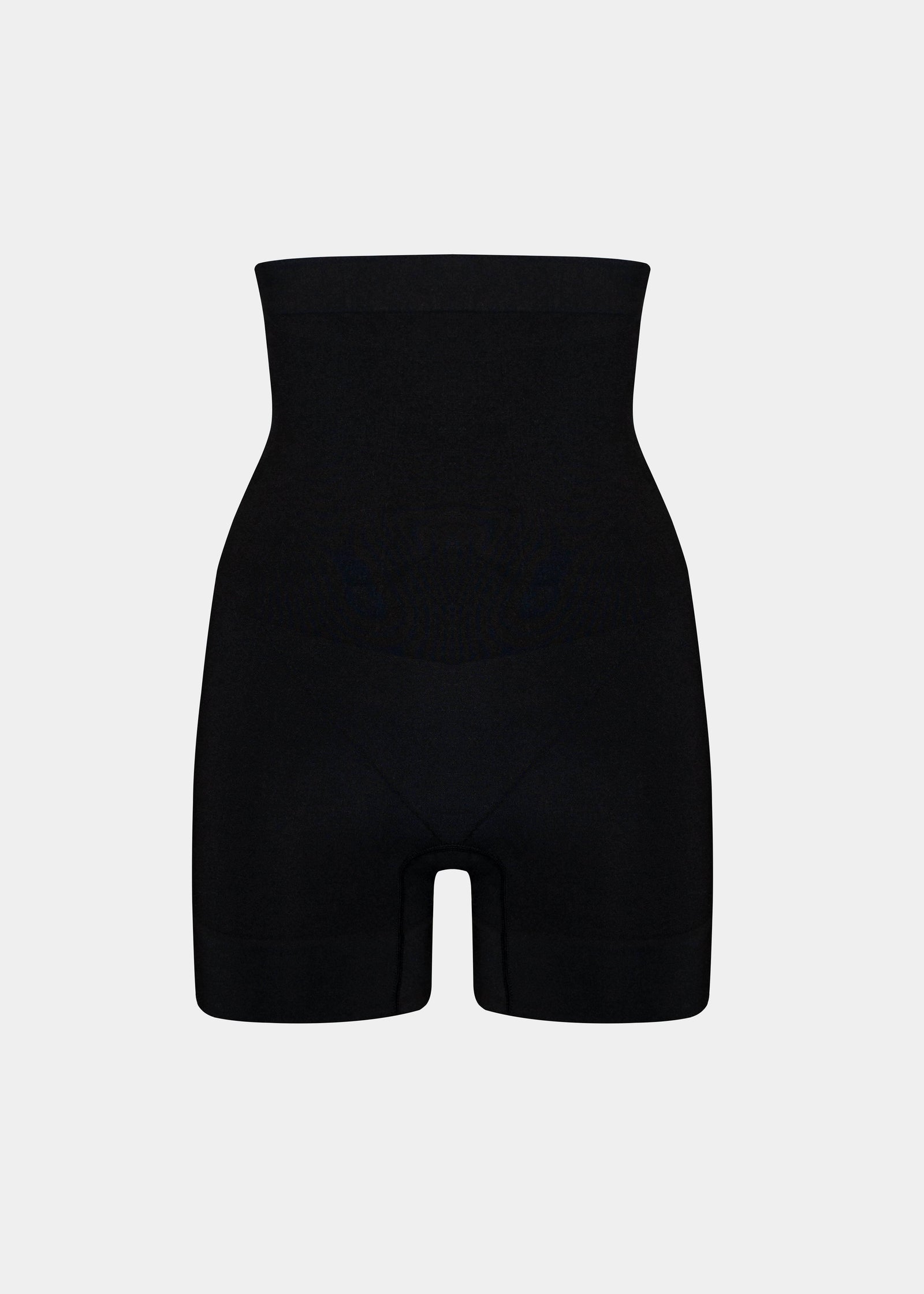 Still product image of Comfort Shaper in black, high-waist seamless shaping shorts. Smooth stretchable fabric with medium shaping for tummy, waist, back, and thighs, featuring silicone trim at waistband and leg openings and a reinforced zone to lift the bottom.