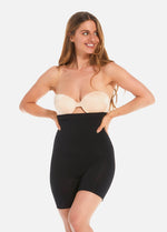 Front view of a model wearing Comfort Shaper in black, high-waist seamless shaping shorts. Smooth stretchable fabric providing medium shaping for tummy, waist, hips, and thighs, with silicone trim at waistband and leg openings and a reinforced zone lifting the bottom.