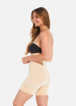 Side view of a model wearing Comfort Shaper in latte, high-waist seamless shaping shorts. Smooth stretchable fabric with medium shaping for tummy, waist, back, and thighs, featuring a special power zone to lift the bottom and silicone trim at top and leg openings.
