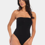 Front view of a model wearing the black Bandeau Thong Body, featuring a seamless, wireless bandeau design with built-in bust support, medium shaping through the waist and tummy, and a smooth, strapless silhouette.