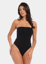 Front view of a model wearing the black Bandeau Thong Body, featuring a seamless, wireless bandeau design with built-in bust support, medium shaping through the waist and tummy, and a smooth, strapless silhouette.