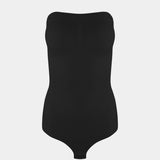 Still front product view of the black Bandeau Thong Body, highlighting the seamless bandeau neckline with silicone trim, built-in bust support, medium shaping through the waist and tummy, and a smooth, wireless finish.