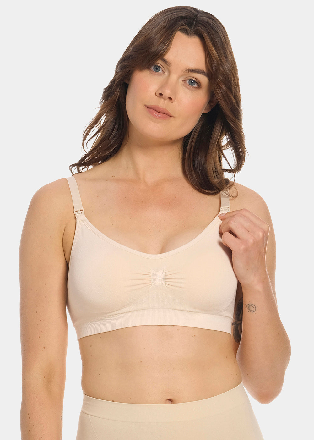 Front view of a model wearing Mama Comfort Nursing Bra in latte, seamless wire-free nursing bra. Clip-down cups, adjustable straps, and smooth stretchable fabric visible, designed for nursing access and support.