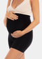 Front view of a model wearing Mama Supporting Short in black, over-the-bump seamless maternity shapewear shorts. Smooth stretchable fabric with mid-thigh length and supportive belly panel, designed for support and invisible wear under clothing.