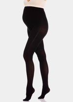 Front view close-up of a model wearing Mama Supporting Tights in black, 80 denier maternity tights. Seamless opaque fabric covering legs and over-the-bump area, showing stretchable material and smooth finish.