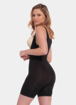 Side view of a model wearing the Seamless Bodysuit in a wear-your-own-bra style, featuring comfortable seamless fabric with medium shaping through the tummy, waist, back, and upper thighs. The design includes subtle lift zones at the bust and bottom, a smooth invisible finish, and a flattering sculpted fit.